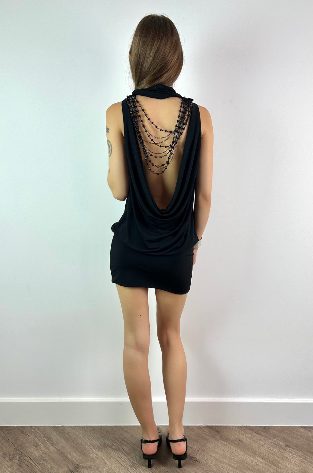 Black Mini Dress with Open Back and Beaded Necklace